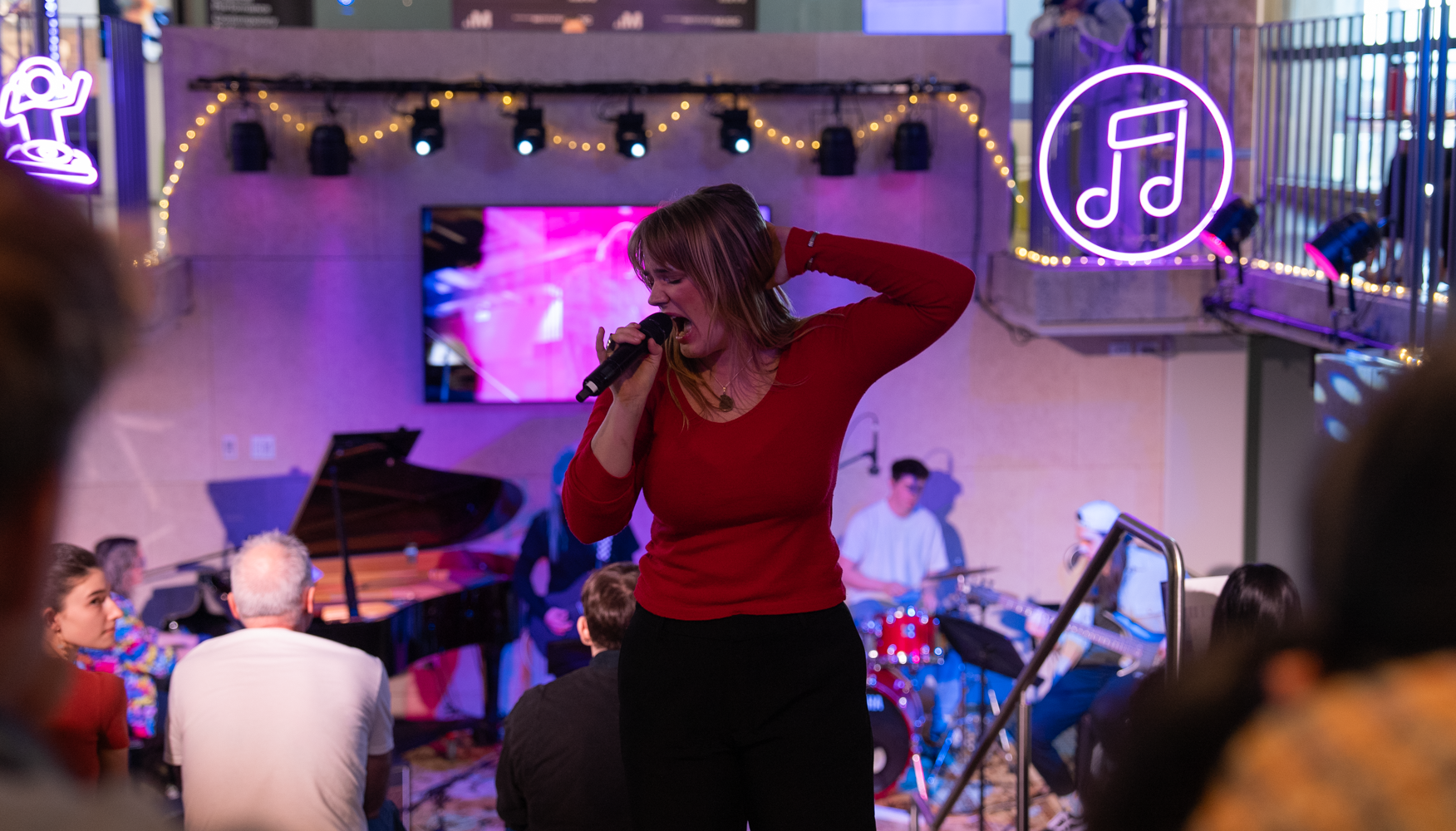 girl-singing-on-stage-with-microphone