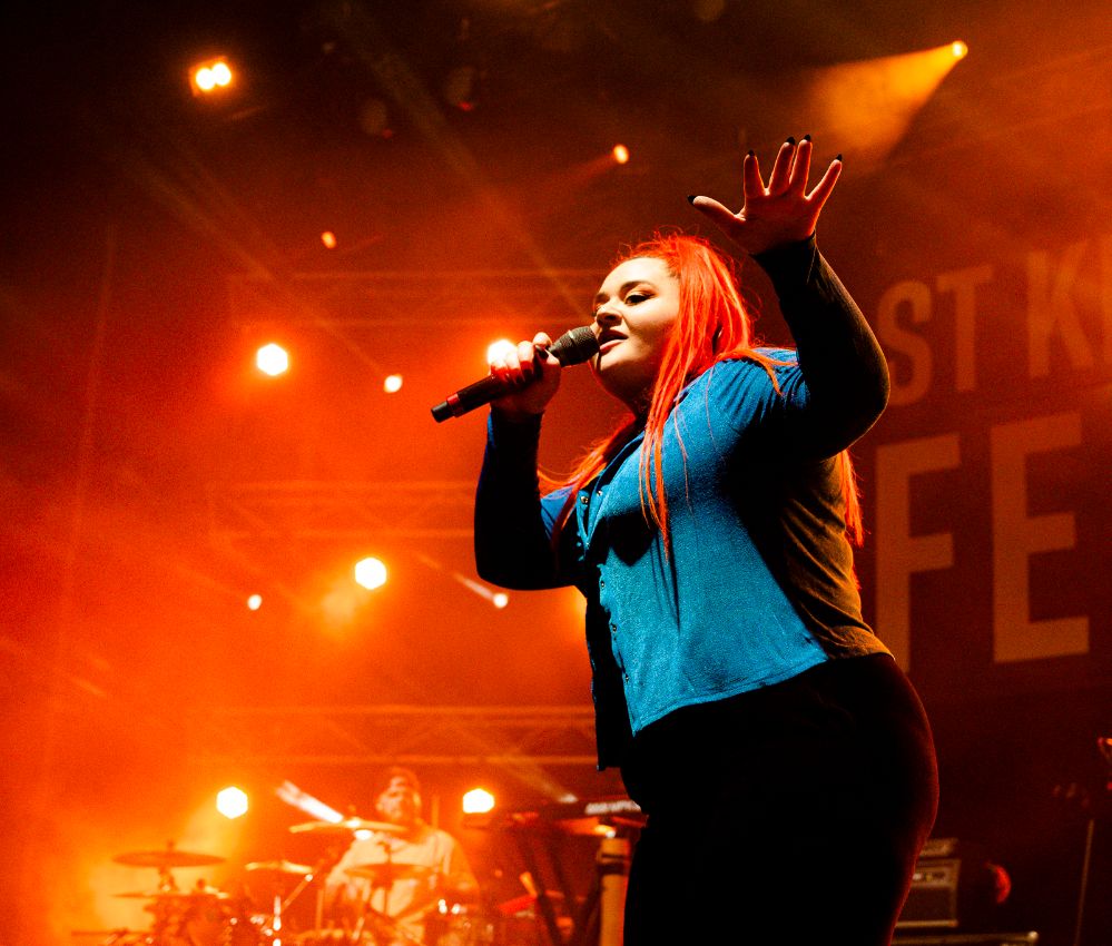 A female vocalist performing on stage