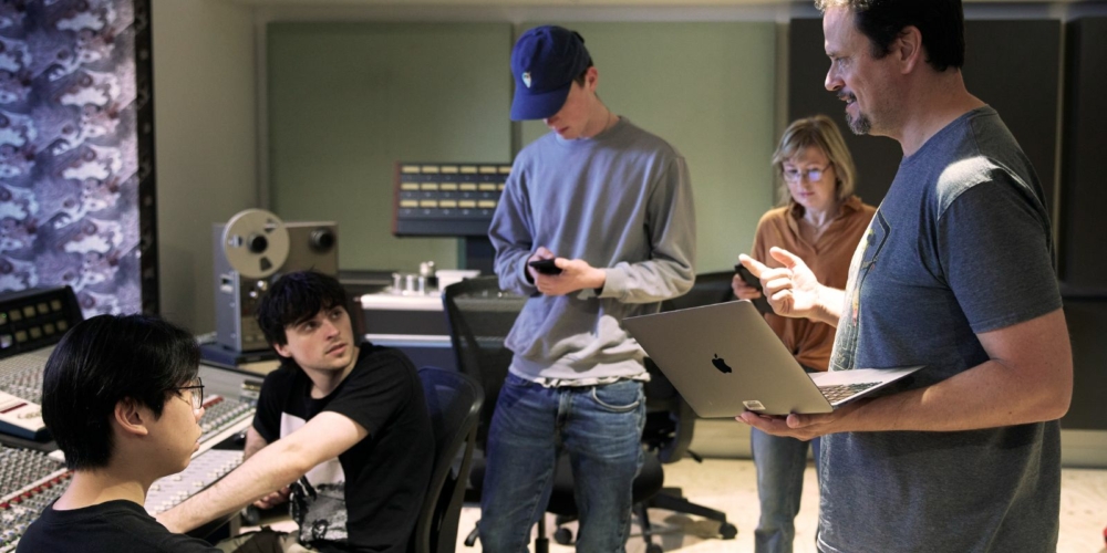 Group of students talking to teachers in a recording studio