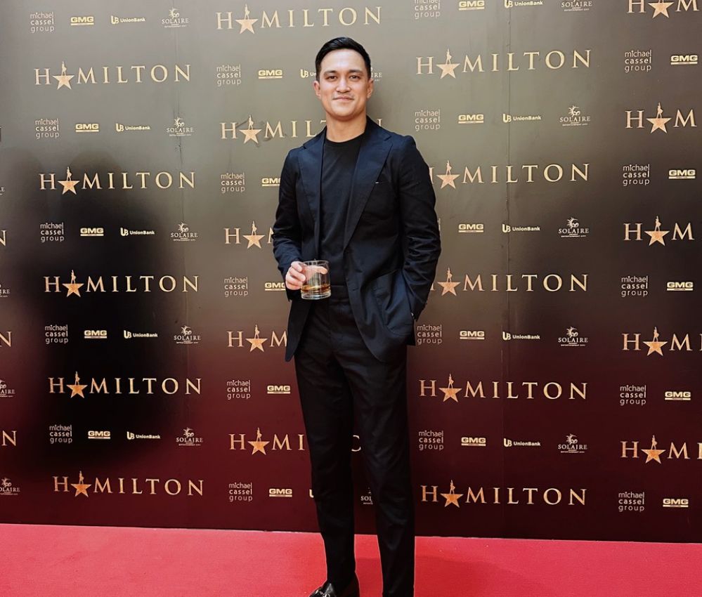 A man standing in front of a Hamilton media wall.