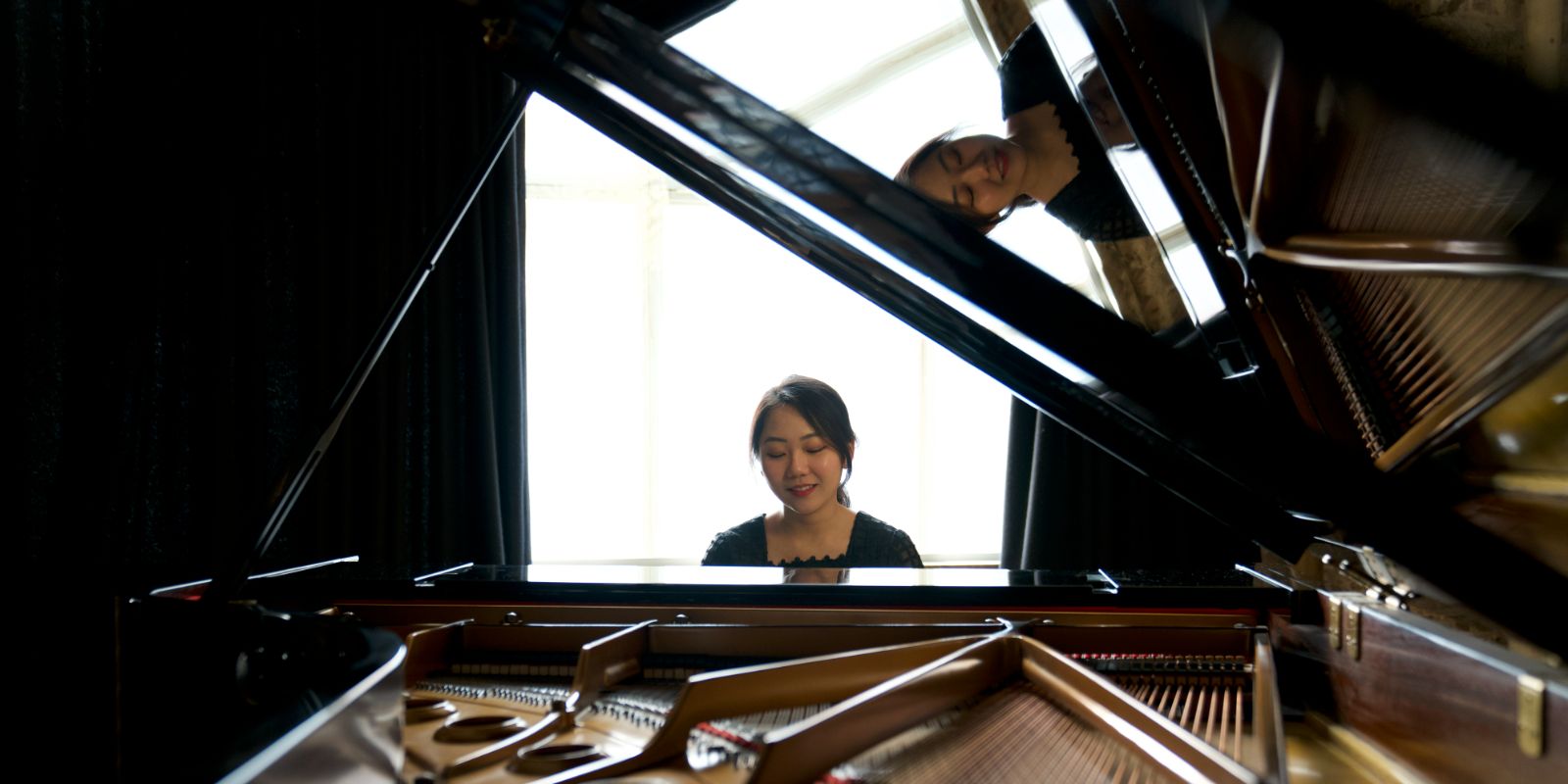 A woman playing a piano