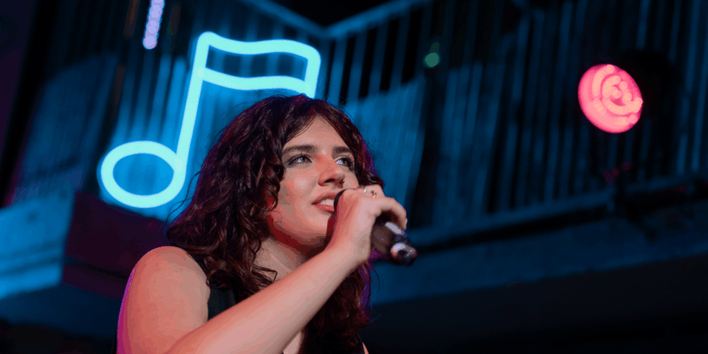 girl-singing-amplify-gig-on-stage-microphone-solo