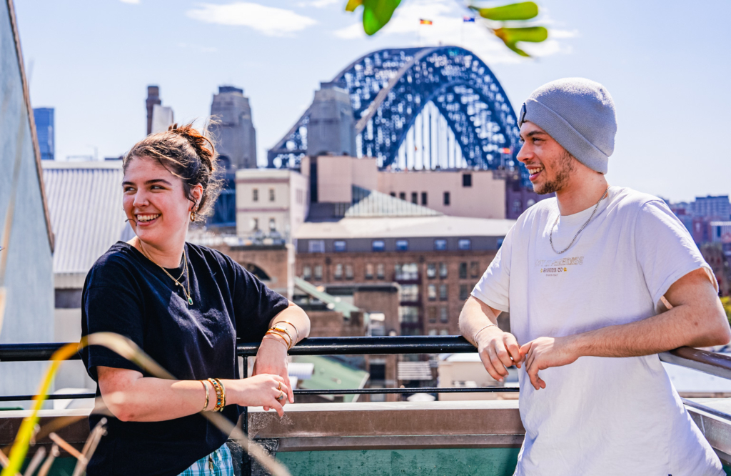 Two students standing in front of the harbour bridge