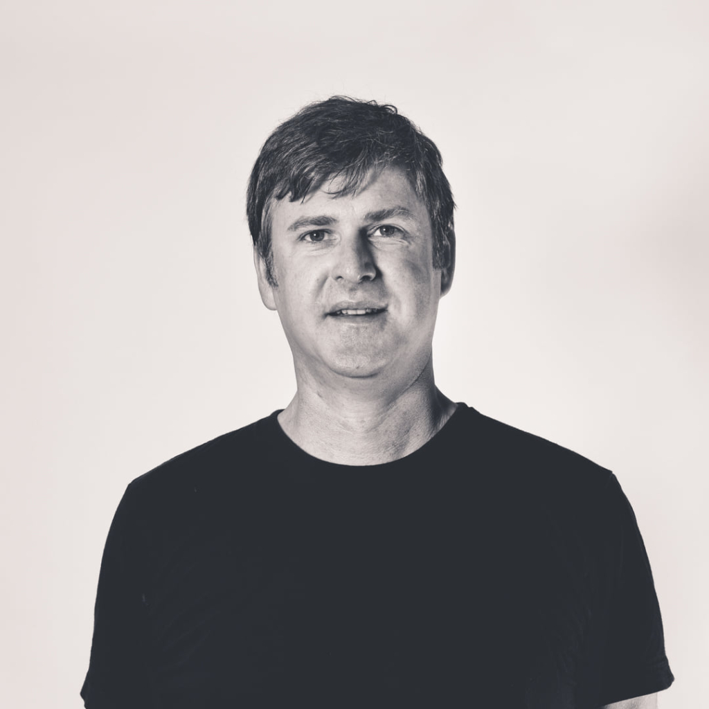 A black and white headshot of Justin Cosby