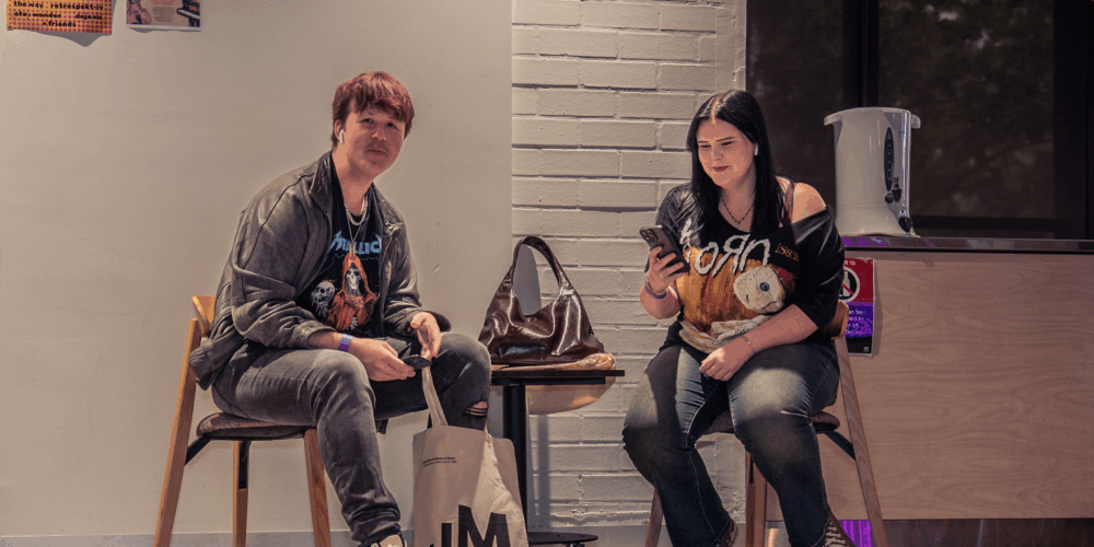 Two students sitting around a table.