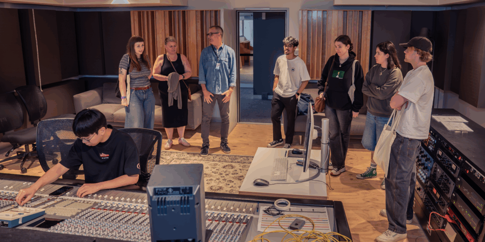 Students and parents in a recording studio.