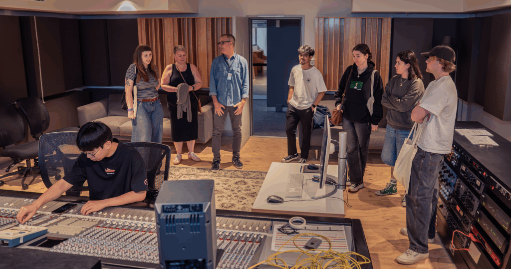Students and parents in a recording studio.
